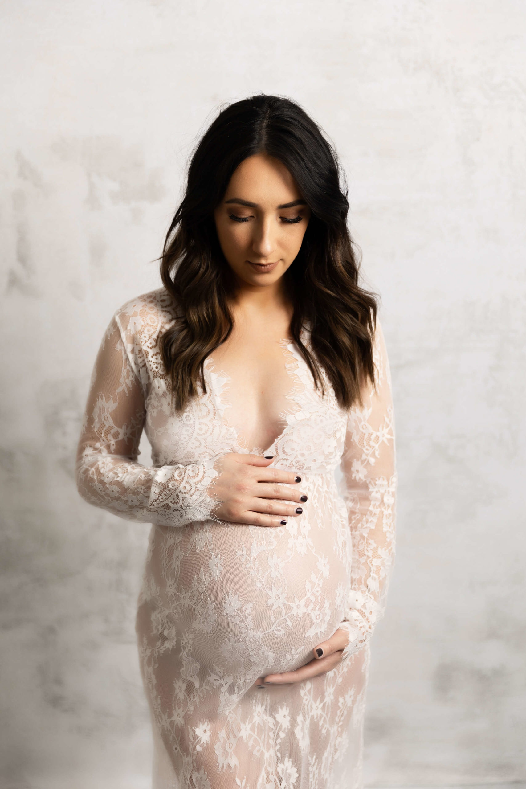 Maternity photo of a girl in a lace dress in an Erie PA studio