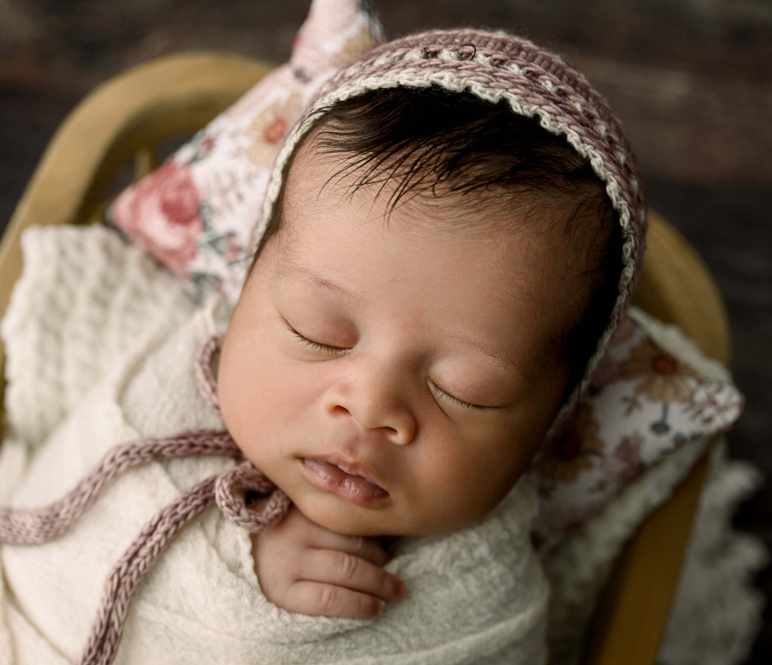Newborn baby girl wearing a bonnet