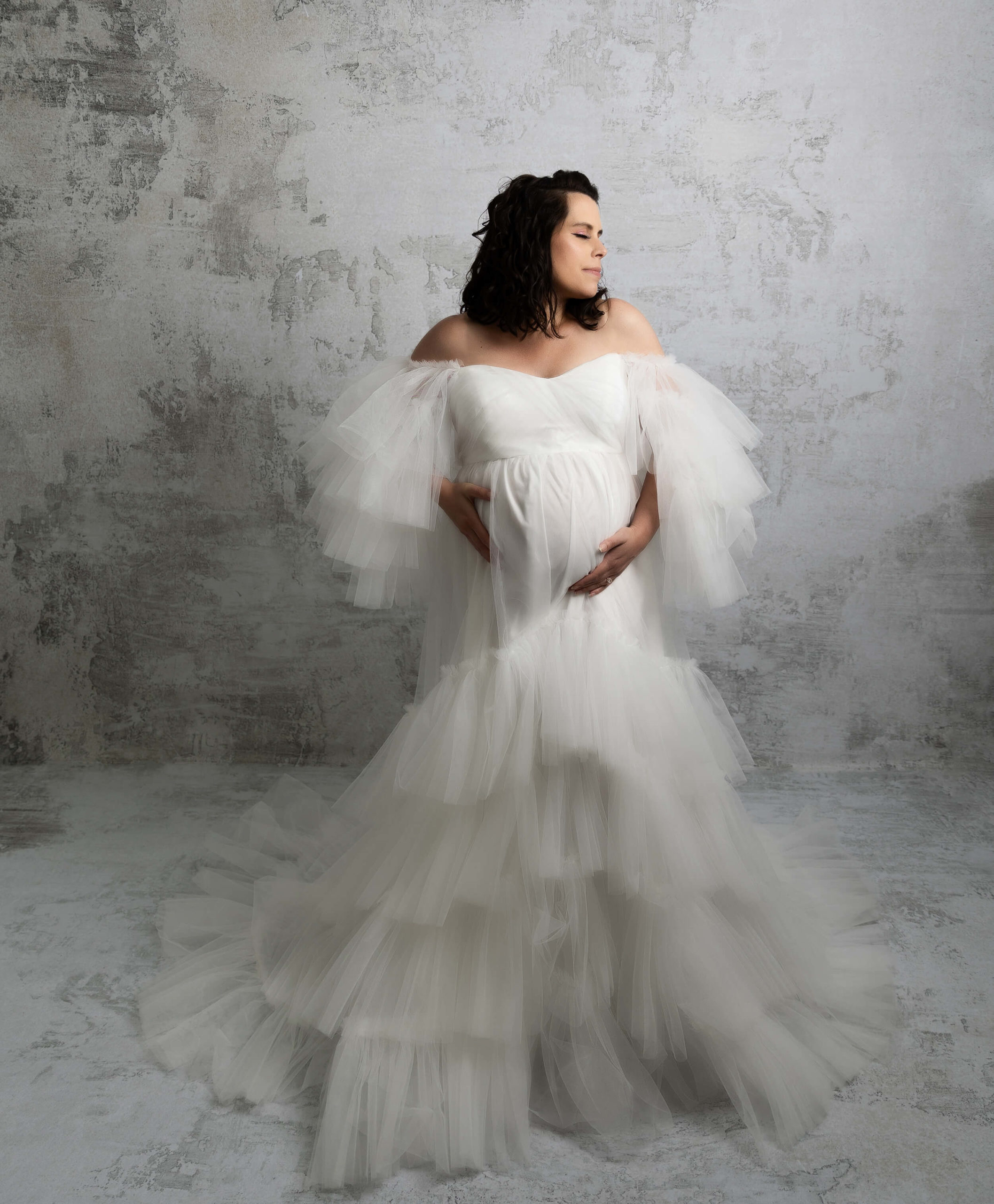 Photo of a pregnant mother in a white fluffy dress