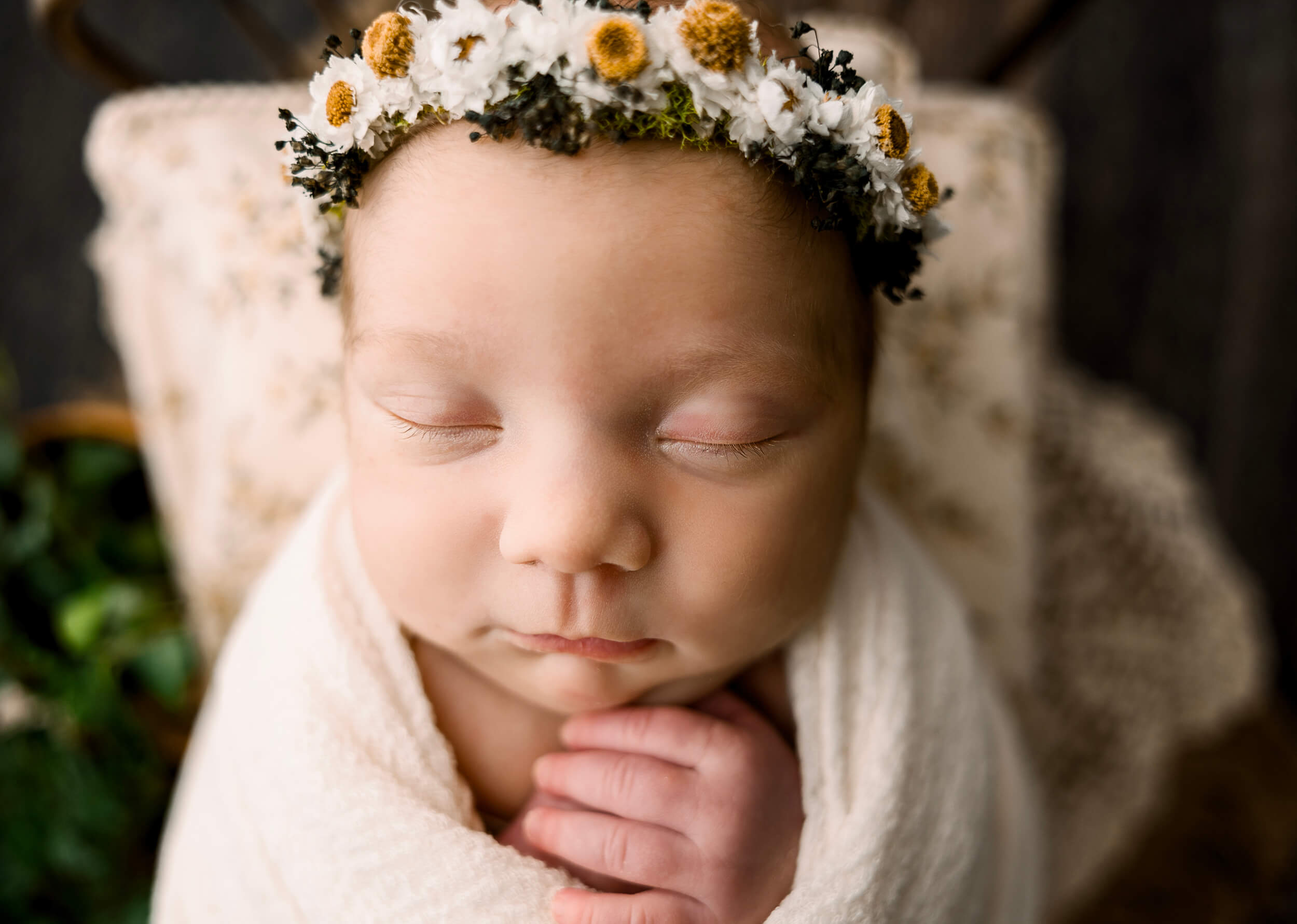 Newborn baby girl with a sunflower headband
